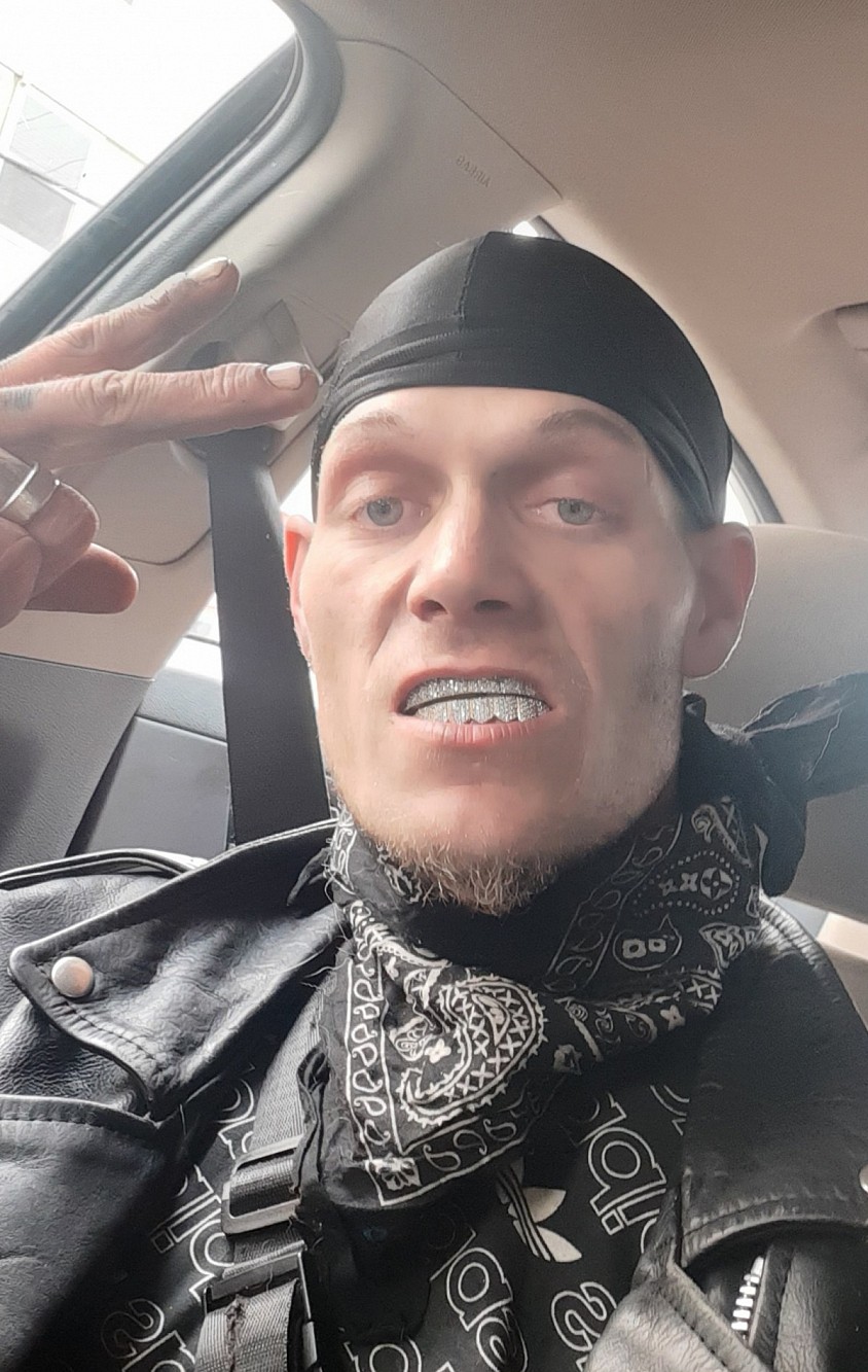 0N3R1 Tha Wicced 1 With 2 tone 24 karat gold grillz with black durag sitting in his 2000 Mercedes Benz CLS500Hold